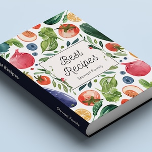 Puede incluir: Un libro de cocina blanco con un diseño de acuarela colorido de verduras y frutas. El título del libro es "Best Recipes" y el autor es "Stewart Family".