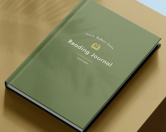 May include: Green reading journal with the text "Reading Journal" and "Track. Reflect. Grow."  The journal has a gold book icon and the text "HABITONIA" on the front cover.
