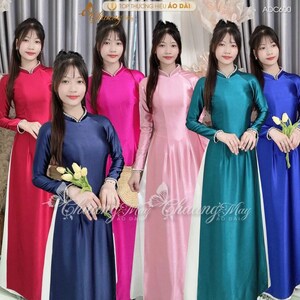 May include: A group of women wearing colorful, long-sleeved dresses. The dresses come in various colors, including red, pink, blue, and teal. Each dress has a white panel on the front and a mandarin collar. The text "TOP THƯƠNG HIỆU ÁO DÀI" is visible.