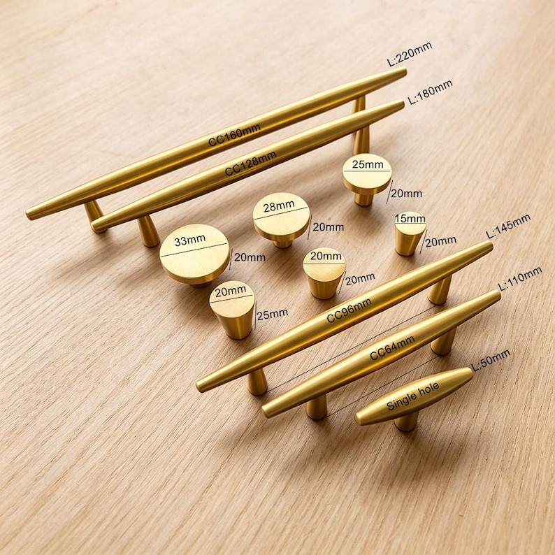 May include: A collection of brushed gold cabinet hardware including various sizes of bar pulls and round knobs. The pulls feature centre-to-centre measurements of 64mm, 96mm, 128mm, and 160mm, while the knobs range from 15mm to 33mm in diameter.