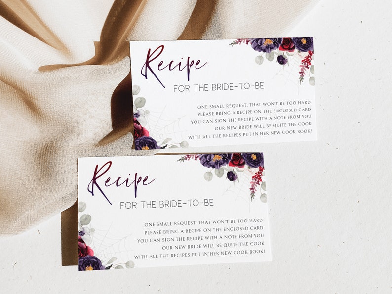 May include: Two white cards with a floral design and the text "Recipe for the Bride-to-Be". The text on the cards reads: "One small request, that won't be too hard. Please bring a recipe on the enclosed card. You can sign the recipe with a note from you. Our new bride will be quite the cook! With all the recipes put in her new cook book!"
