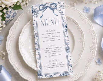 May include: A vertical rectangular menu card featuring a blue and white floral pattern with a bow illustration at the top. The text reads MENU, STARTER, ENTREE, and DESSERT, followed by a list of food items including goat cheese, salad, and cake.