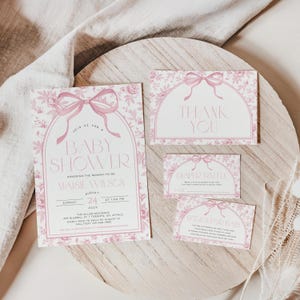 May include: A baby shower invitation suite with a pink floral design. The invitation includes the text "Baby Shower" and event details. Additional cards say "Thank You", "Diaper Raffle", and "Books for Baby".