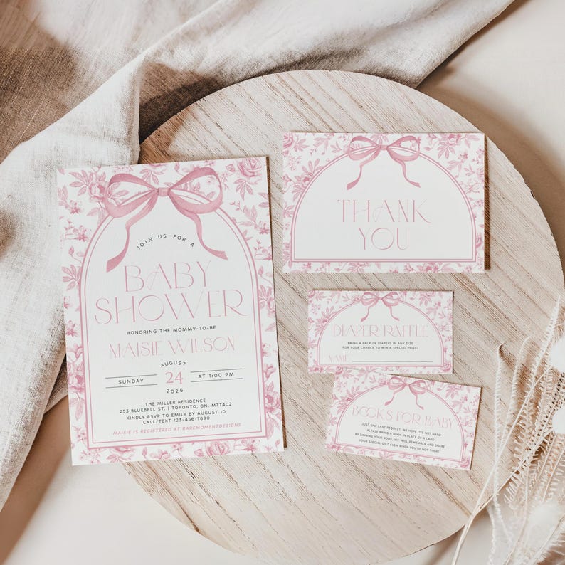 May include: A baby shower invitation suite with a pink floral design. The invitation includes the text "Baby Shower" and event details. Additional cards say "Thank You", "Diaper Raffle", and "Books for Baby".