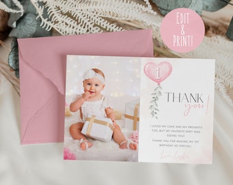 May include: Pink and white thank you card with a photo of a baby girl holding a gift. The card has a pink balloon with the number 1 on it and the text "Thank you!"  The text on the card reads "I loved my cake and my presents too, but my favorite part was seeing you! Thank you for making my 1st birthday so special!"