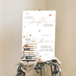 Cartello di benvenuto &quot;Un nuovo capitolo inizia&quot;, cartello di benvenuto &quot;Un nuovo capitolo inizia&quot; per addio al nubilato, cartello di benvenuto con libro di fiabe, poster di benvenuto con libro floreale