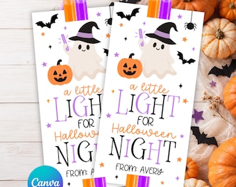 May include: Two rectangular white paper tags featuring a cartoon ghost wearing a purple-banded black witch hat, an orange jack-o'-lantern, and bats. The text reads A LITTLE LIGHT FOR HALLOWEEN NIGHT FROM: AVERY. Each tag holds orange and purple glow sticks.