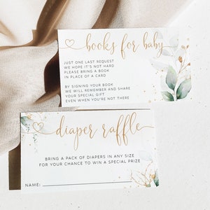 May include: Two white cards with gold lettering and watercolor greenery. The top card says "books for baby" and has instructions for guests to bring a book instead of a card. The bottom card says "diaper raffle" and has instructions for guests to bring a pack of diapers for a chance to win a prize.
