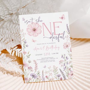 May include: A white rectangular birthday invitation card featuring pink and purple floral illustrations, butterflies, and the text: isn't she ONEderful, PLEASE JOIN US TO CELEBRATE, Ava's 1st Birthday, AUGUST 29, 1:00 PM, MILLER RESIDENCE, 430 BLOSSOM LANE, TORONTO, ON.