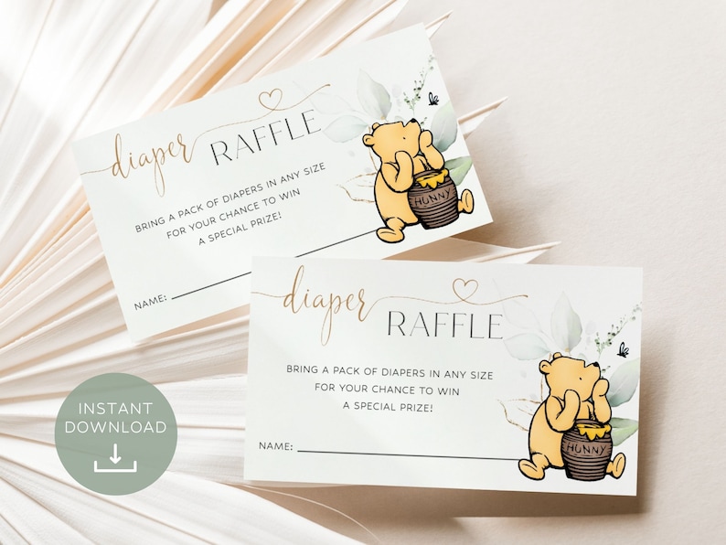 Peut inclure: Deux billets de tombola pour une f&ecirc;te pr&eacute;natale imprimables avec une illustration de Winnie l'ourson et le texte "tombola couches" et "Apportez un paquet de couches de n'importe quelle taille pour avoir une chance de gagner un prix sp&eacute;cial !"