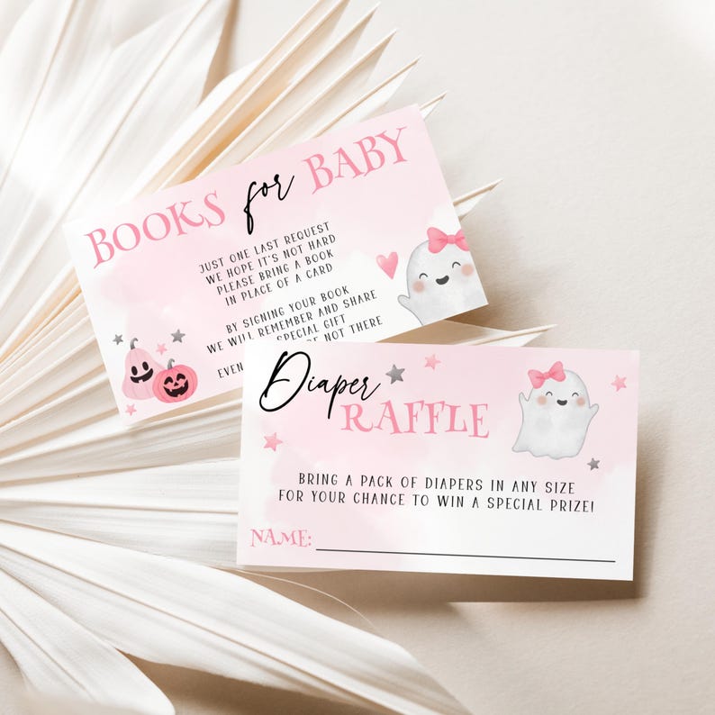 May include: Two rectangular cards with a light pink background featuring ghost illustrations with pink bows, small stars, and pink pumpkins. The top card reads BOOKS FOR BABY and the bottom card reads Diaper RAFFLE with text instructions and a name line.