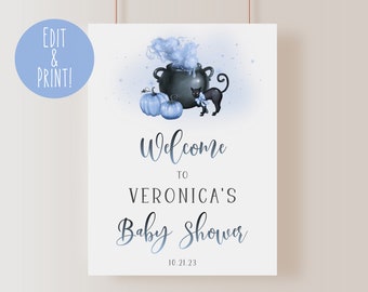 May include: A blue and white baby shower welcome sign with a black cat, a cauldron, and pumpkins. The text reads "Welcome to Veronica's Baby Shower 10.21.23".