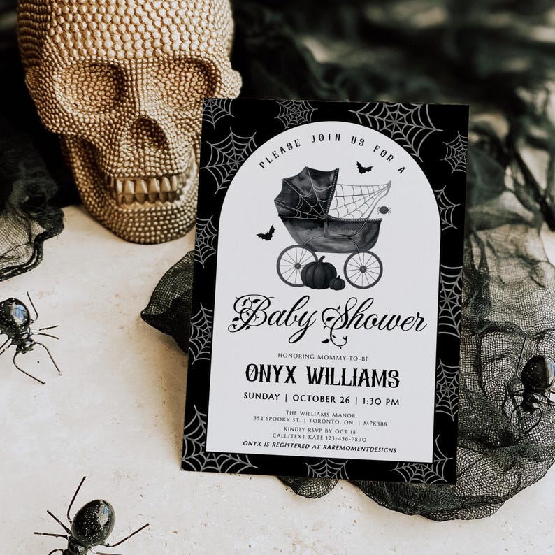 May include: A black and white baby shower invitation with a spooky theme. The invitation features a baby carriage, bats, and spiderwebs. The text reads "Baby Shower" and includes event details.