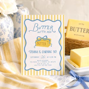 May include: A rectangular birthday invitation card with yellow and white vertical stripes, featuring a blue scalloped border and a central illustration of a yellow butter block with a blue ribbon. Text reads: Butter with age, Briana is churning 30!, September 26 at 6:00 PM, Miller Residence, 932 Maple St, Toronto, ON, M8T2V3, RSVP by Sept 20, Call/Text 123-456-7890.
