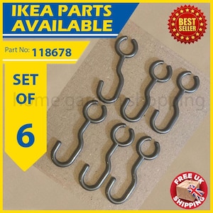 May include: A set of six dark gray metal IKEA hooks. The hooks have a curved design with a circular opening at the top and a hook at the bottom. The image includes text that says "IKEA PARTS AVAILABLE" and "SET OF 6".
