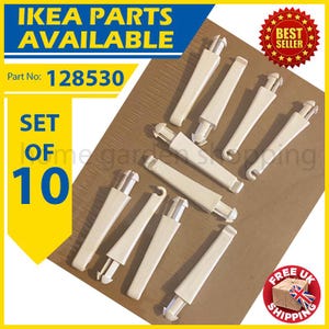 May include: A set of ten off-white IKEA furniture parts, model number 128530, arranged on a brown surface. The parts are rectangular with a curved end and a hook-like feature. The image includes text that says "IKEA PARTS AVAILABLE" and "SET OF 10".