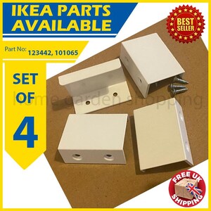 May include: A set of four white IKEA furniture parts. The image includes the text "IKEA PARTS AVAILABLE" and "SET OF 4". The parts are rectangular with screw holes and are displayed on a brown surface. The part numbers are 123442 and 101065.