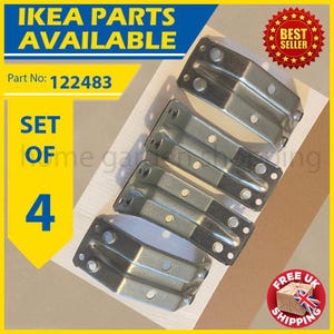 May include: A set of four silver-colored IKEA furniture corner brackets. The brackets are made of metal and have multiple holes for screws. The image includes text that says "IKEA PARTS AVAILABLE" and "SET OF 4".