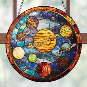 May include: A stained glass suncatcher featuring a colorful depiction of the solar system with planets, stars, and a galaxy background.