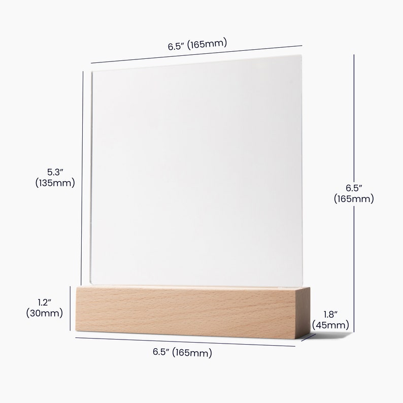 May include: A clear acrylic sign holder with a wooden base. The sign holder is 6.5 inches tall and 5.3 inches wide. The base is 1.8 inches tall and 6.5 inches wide.