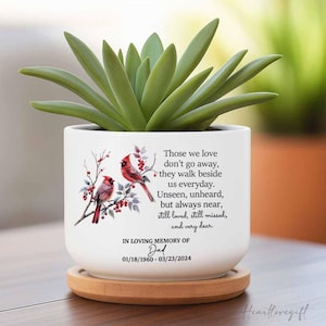 May include: White ceramic planter with a quote about those we love, featuring two red cardinals on a branch with red berries. The planter has the text "In loving memory of Dad 01/18/1960 - 03/23/2024".
