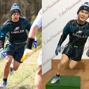May include: A person in a teal and black football uniform with the word "EAGLES" on the chest, wearing a blue and white beanie. The person is running on a field. A figurine of the person is also shown.