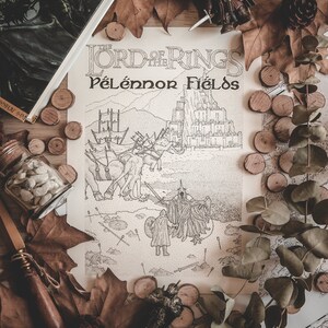 May include: A black and white illustration of the battle of Pelennor Fields from The Lord of the Rings. The illustration is surrounded by fall leaves, wooden discs, and a small figurine of Aragorn.