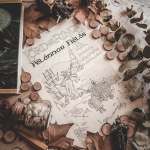May include: A close-up of a Lord of the Rings themed illustration featuring the text "Lord of the Rings Pelennor Fields". The illustration depicts a battle scene with figures and horses. The illustration is surrounded by autumn leaves, wooden discs, a small figurine, and a glass jar filled with white stones.