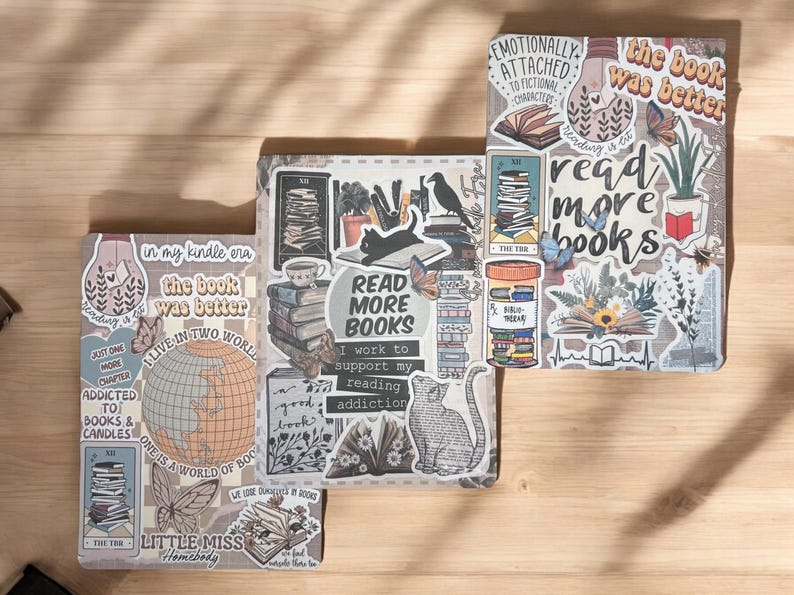May include: Three decorated notebooks with a book and reading theme. The notebooks have a variety of stickers, including a cat, a globe, a stack of books, and a quote that says "Read More Books".