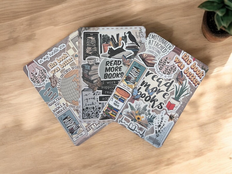 May include: Three different notebooks with various book-themed stickers. The stickers feature phrases like "Read More Books", "The Book Was Better", and "Emotionally Attached to Fictional Characters".