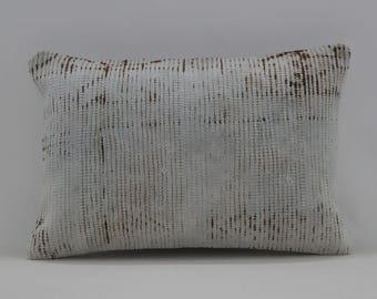 May include: White throw pillow with a subtle brown woven pattern. The pillow is made of a soft, textured fabric.