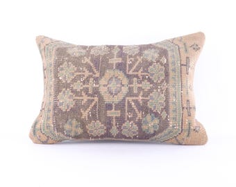 May include: A rectangular throw pillow with a beige background and a brown and green floral pattern.