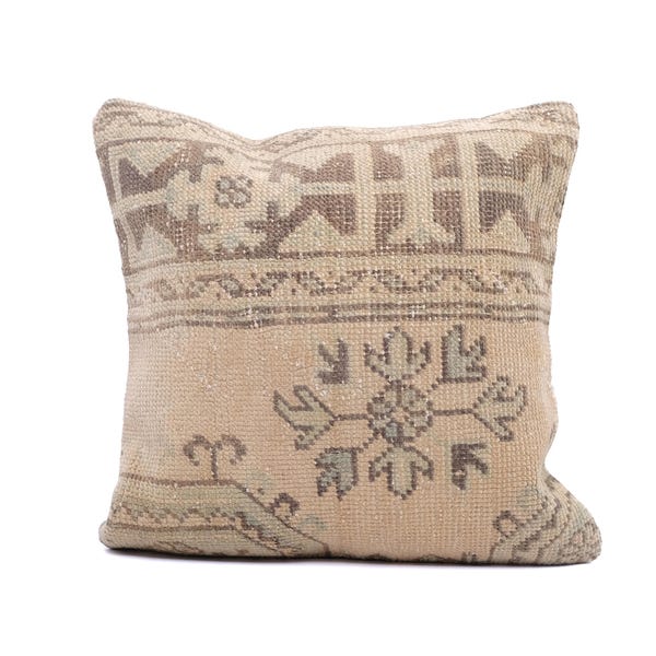 May include: Square decorative pillow with a beige and brown geometric pattern. The pillow features a central floral design and a border with cross-like shapes. The fabric has a slightly worn, vintage appearance, adding to its charm.