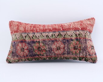 May include: A red, green and blue patterned throw pillow with a geometric design. The pillow is made of a soft, woven fabric.