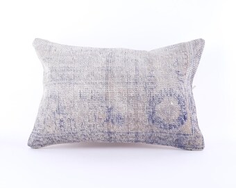May include: A rectangular grey and blue throw pillow with a woven texture.
