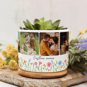 May include: White ceramic planter with a succulent plant. The planter features family photos and a floral design with the text "Custom name". It sits on a wooden base.