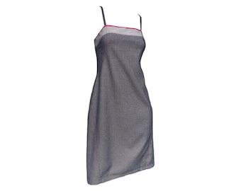 May include: A sleeveless denim dress with a red and white trim around the neckline.