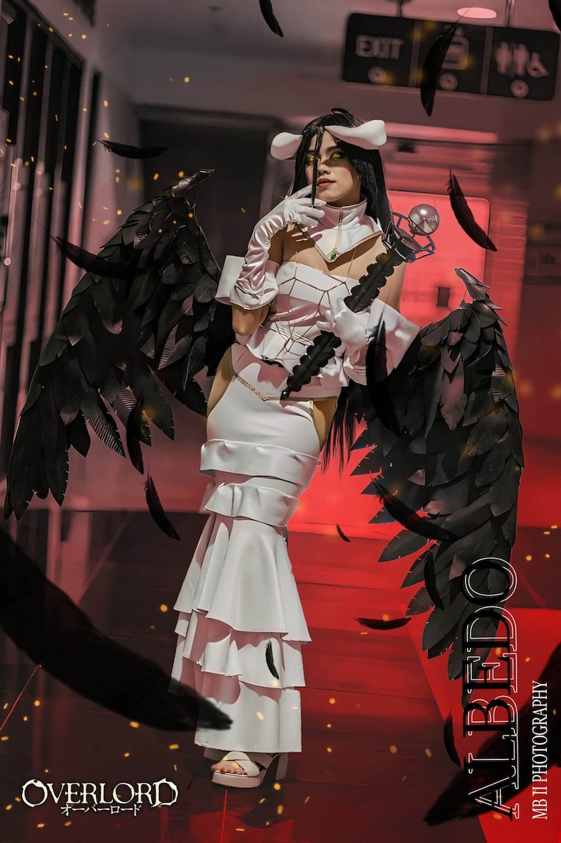 May include: A woman in a white dress with black angel wings, posing in a hallway with red walls. The text "ALBEDO" is written vertically on the right side of the image. The text "OVERLORD" is written in Japanese and English at the bottom of the image.