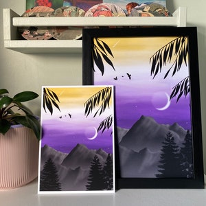 May include: Two framed prints of a purple and yellow gradient sky with black silhouettes of trees and mountains. The smaller print is on a white background and the larger print is on a black background.