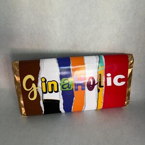 May include: A chocolate bar with a colorful, torn paper wrapper that reads "Gin-a-holic".