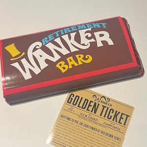 May include: A novelty chocolate bar with the text "RETIREMENT WANKER BAR" in white and yellow on a brown background. A "Golden Ticket" is next to the bar, with text that reads "WANKER GOLDEN TICKET".