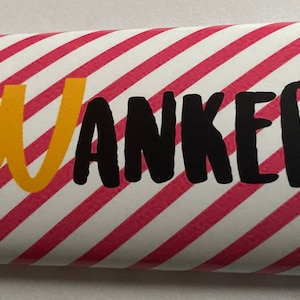 May include: A red and white striped candy bar wrapper with the word "WANKER" printed in black letters. The letter "W" is in yellow.