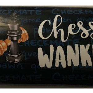 May include: A black and white chocolate bar with a chess piece design and the text "Chess Wanker" printed on it.