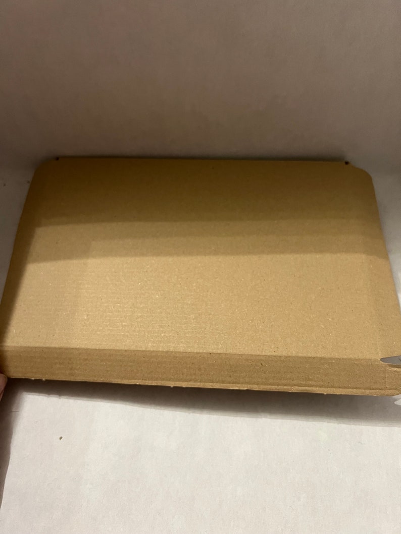 May include: A brown cardboard box with a textured surface. The box is open and empty.