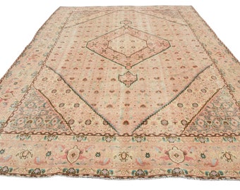 May include: A vintage Persian rug with a light pink background and a central diamond-shaped design. The rug features a detailed floral pattern in shades of blue, green, and brown.