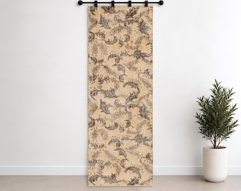 May include: A rectangular wall hanging featuring a tan background with a repeating dark gray botanical pattern of leaves and fern-like fronds. The textile is suspended from a black horizontal rod with four black clips along the top edge.