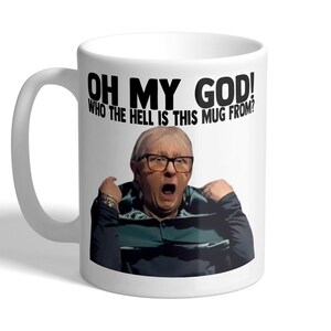 May include: White ceramic mug featuring a black and white image of a man wearing glasses and the text "Oh My God! Who the hell is this mug from?"