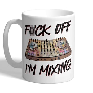 May include: White ceramic mug with a DJ mixer graphic and the text "FUCK OFF I'M MIXING" in black and red. The mug has a curved handle and a glossy finish, suitable for hot or cold drinks.