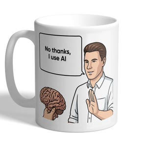 May include: A white ceramic mug featuring a cartoon illustration of a person in a white shirt holding up a hand in a gesture of refusal. A speech bubble above the person contains the text "No thanks, I use AI" next to a brown human brain.