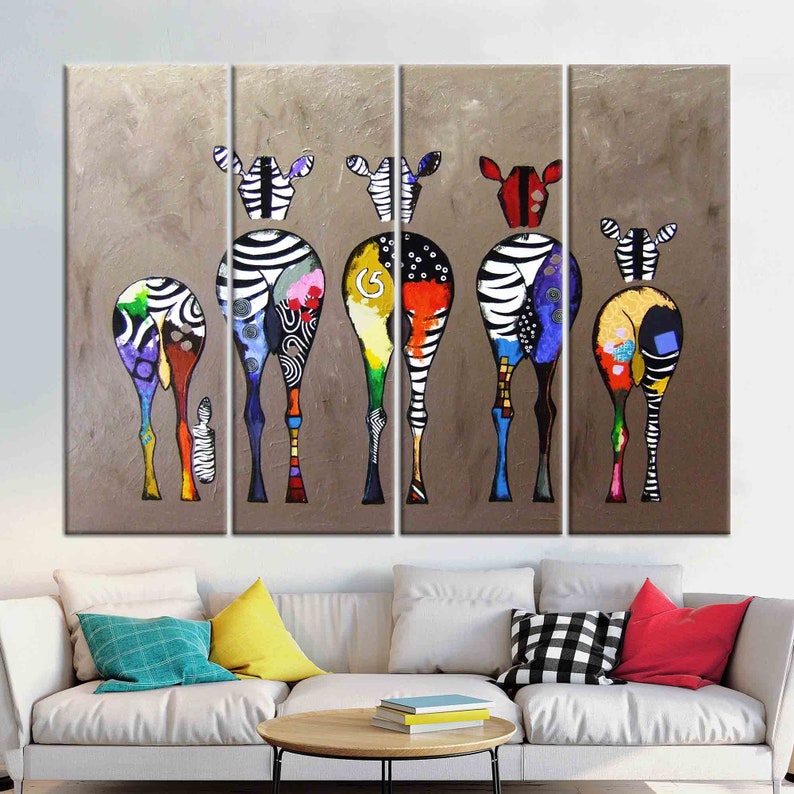 May include: A multi-panel canvas painting featuring a group of colorful zebras with abstract patterns on their bodies. The zebras are facing away from the viewer, and their legs are long and slender. The background is a muted brown color.